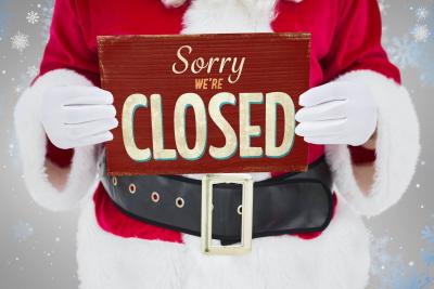 Partial Santa holding Sorry We're Closed sign